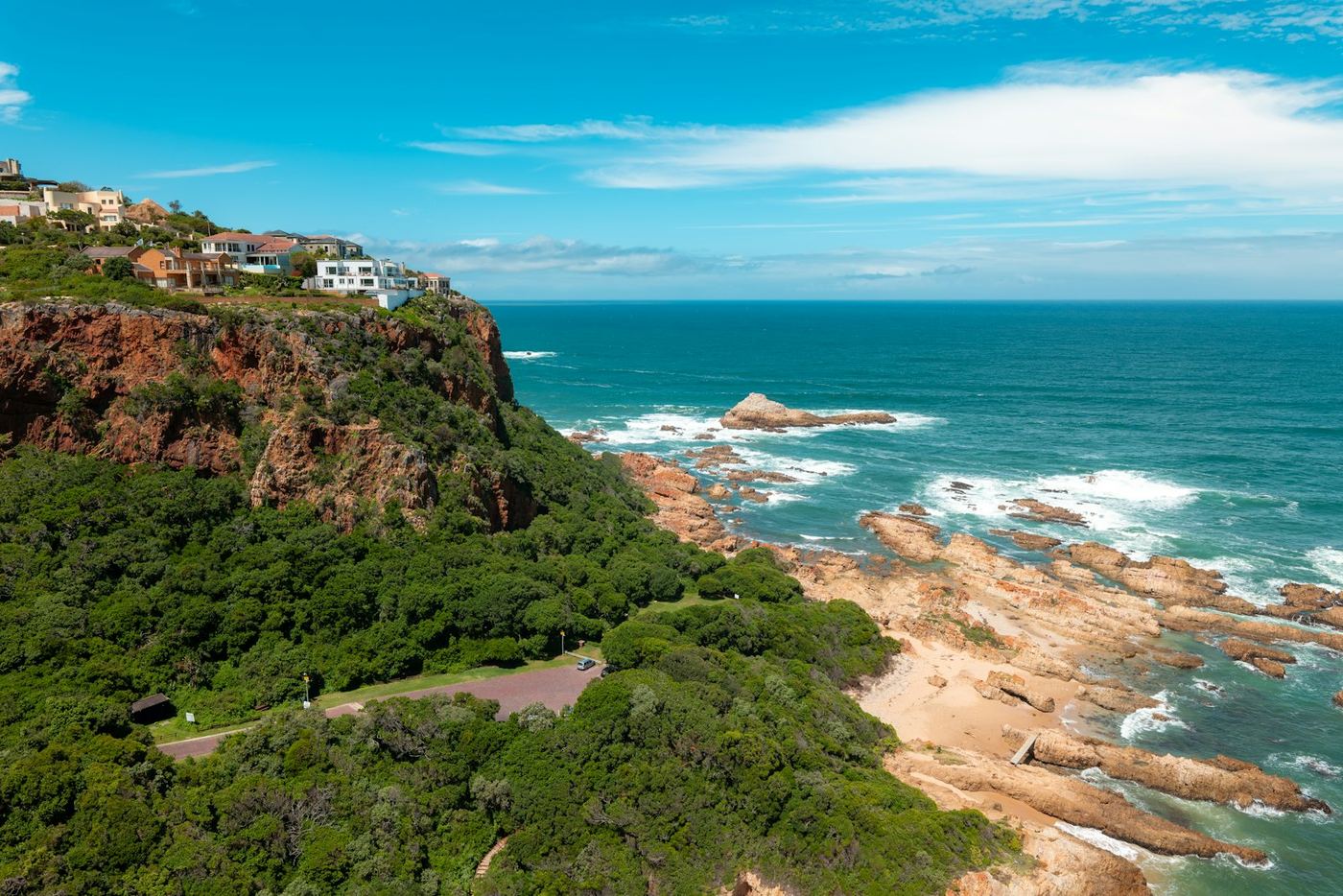 Green coastal cliffs above a turquoise sea